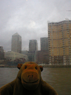 Mr Monkey looking at Canary Wharf from the Thames Clipper