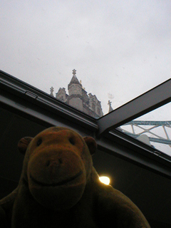 Mr Monkey looking at Tower Bridge through the roof of the Clipper