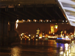 The Houses of Parliament seen through the Hungerford bridges at night