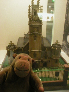 Mr Monkey looking at a model of St Augustine's church