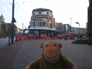 Mr Monkey looking at the burned ruins of the Yates Wine Lodge