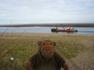 Mr Monkey watching a dredger on the river Wyre
