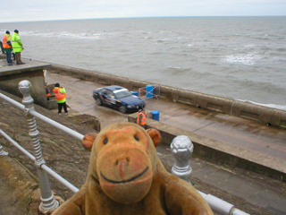 Mr Monkey watching a rally car starting its run