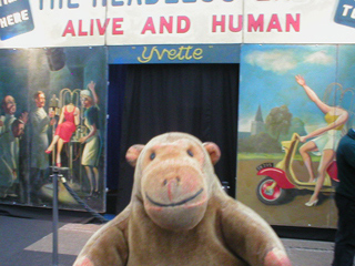 Mr Monkey looking at the Headless Woman sideshow front