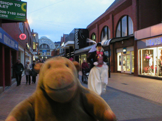 Mr Monkey watching a giant rabbit running down the street