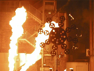 The burned out gear wheel with jets of flame behind it