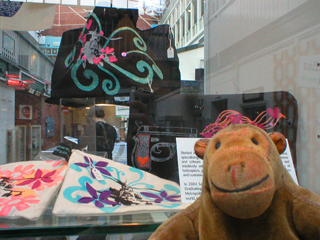 Mr Monkey looking at purses and bags by Guerilla Embroidery