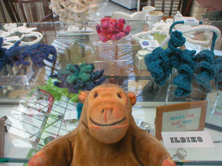 Mr Monkey looking at crocheted pieces by Ildiko Szabo