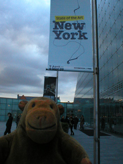 Mr Monkey looking at a banner outside Urbis