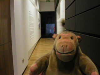 Mr Monkey trotting up the corridor to the exhibition space