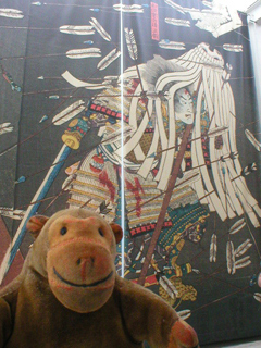 Mr Monkey looking at the banner outside the Kuniyoshi exhibition