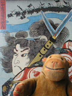 Mr Monkey in front of a print of Kuniyoshi's Sanada Masayuki
