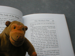 Mr Monkey reading a sinister tale in a newly printed book