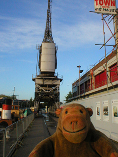 Mr Monkey looking at the cranes on the Bristol quayside