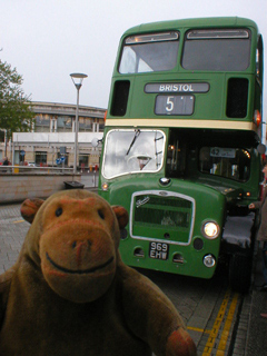 Mr Monkey in front of a Bristol Lodecka bus