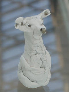 A small ceramic white mouse by Eve Bennett