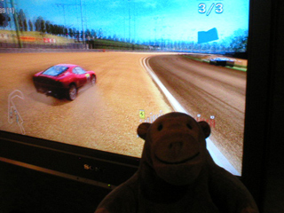 Mr Monkey watching a car racing without flying