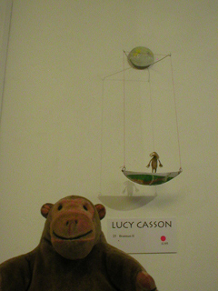 Mr Monkey looking at a Boatman figure by Lucy Casson