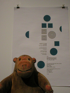 Mr Monkey looking at a poster for the Hot Club