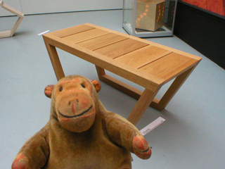 Mr Monkey looking at an oak toboggan table by Clinton Pilkington