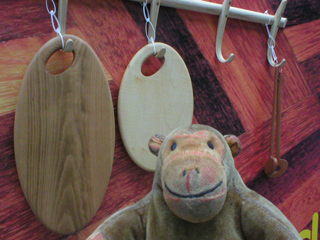 Mr Monkey looking at cutting boards and spoons by Howcroft and Jordan