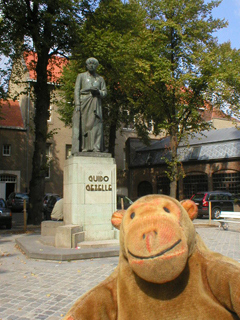 Mr Monkey looking at the statue of Guido Gezelle