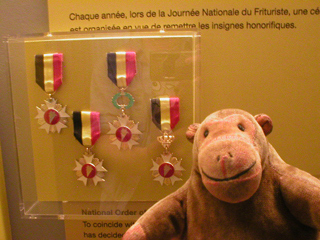 Mr Monkey looking at medals issued by the Union of Friers