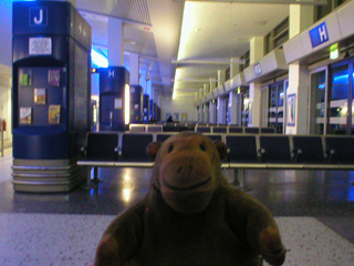 Mr Monkey waiting for a bus at Manchester Ringway