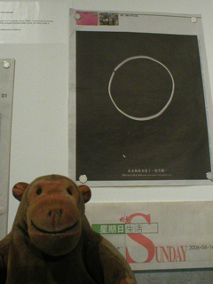 Mr Monkey looking at Ming Pao newspapers
