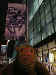 Mr Monkey looking at the Home Grown banner outside Urbis