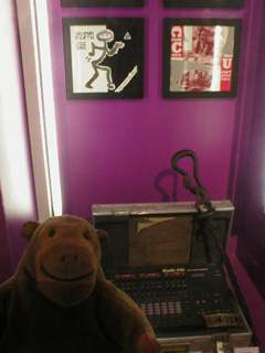 Mr Monkey looking at MC Duke's drum machine and walking stick