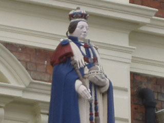 Queen Victoria standing on the porch of the Queen Hotel