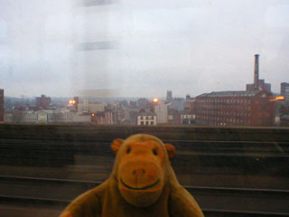 Mr Monkey looking at Stockport from the train