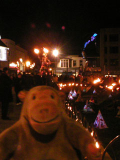Mr Monkey watching the Fire Queen from beside the church