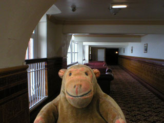 Mr Monkey walking through a corridor in the Tower