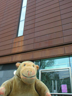 Mr Monkey looking at the COR-TEN cladding of the museum