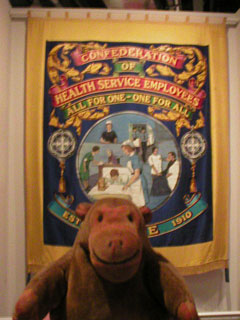 Mr Monkey looking at a COHSE banner