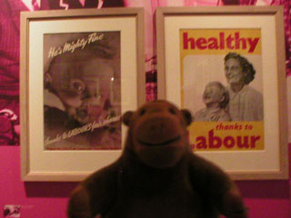 Mr Monkey looking at Labour party posters about the NHS
