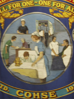 Medical staff on a Confederation of Health Service Employees banner
