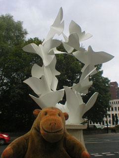 Mr Monkey looking at the Doves of Peace sculpture
