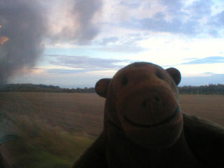 Mr Monkey watching smoke passing the carriage window