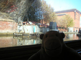 Mr Monkey passing a dredger in Castlefield Basin