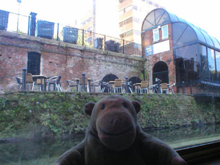 Mr Monkey looking up at the Mark Addy pub