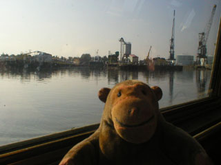 Mr Monkey looking at the docks and cranes on the Trafford Wharf