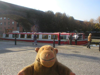 Mr Monkey walking away from the L.S. Lowry canal boat