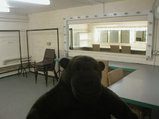 Mr Monkey peeking into a dressing room
