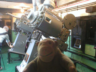 Mr Monkey looking at a row of projectors