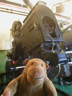 Mr Monkey beside the Kalee 'Indomitable' No. 8 Projector