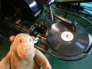 Mr Monkey looking at the record player on the Kalee No. 8 Projector