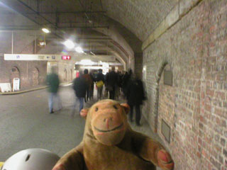 Mr Monkey walking through the underground car park of Manchester Central